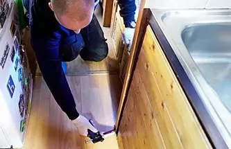 Exterminator providing cockroach treatment